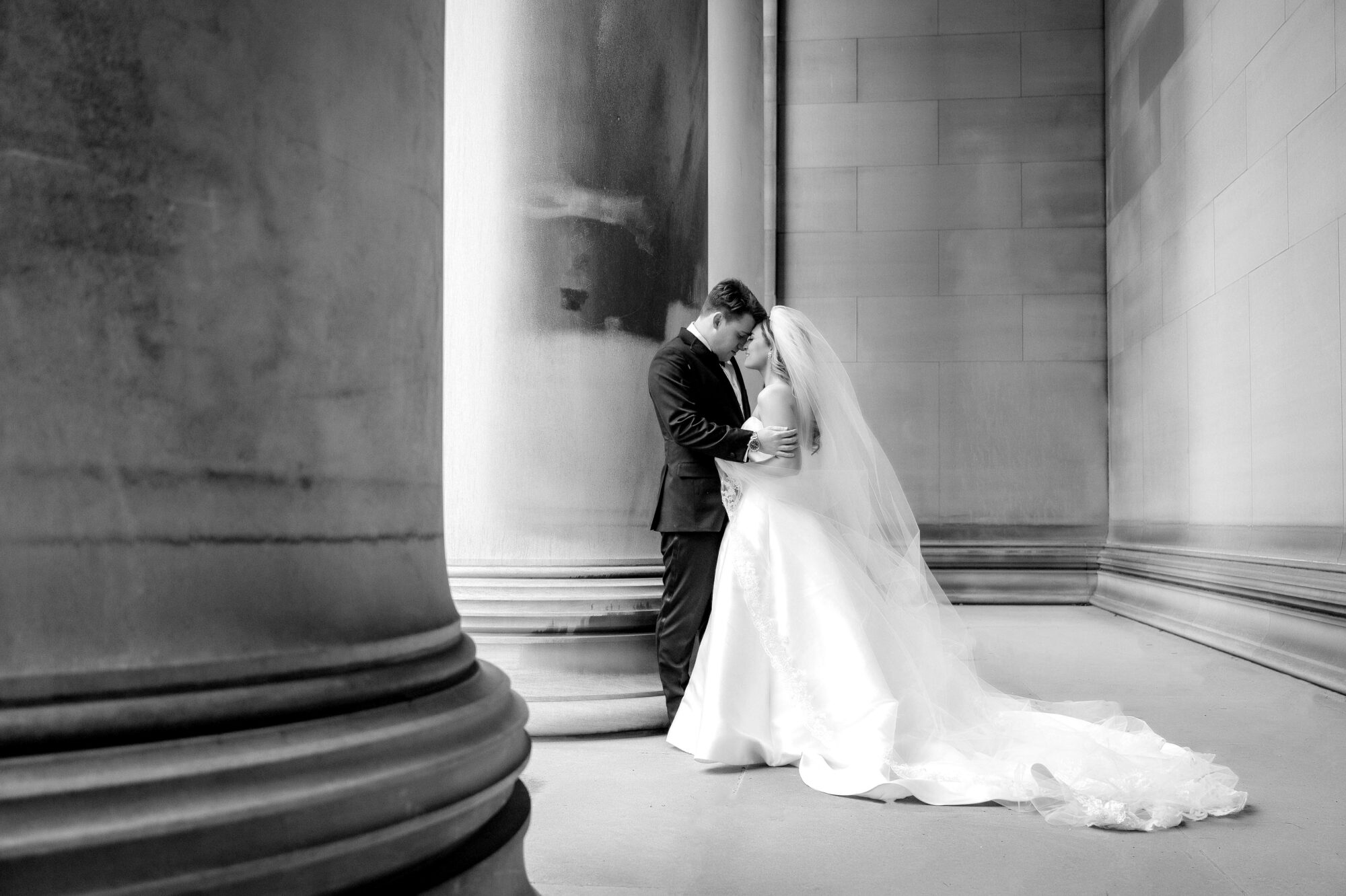 wedding couple in black and white photo at mellon institute columns • Stunning Duquesne Club Wedding Photos - An Elegant Wintery January Pittsburgh Marriage
