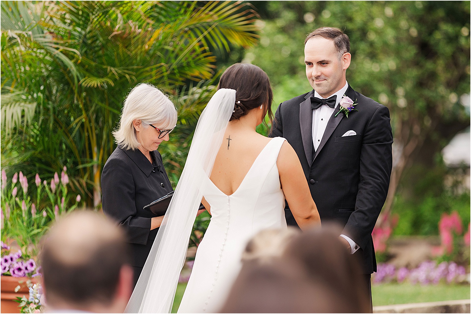 groom looking at bride during wedding ceremony • Wild Weather - Love at a Phipps Conservatory Outdoor Garden Wedding