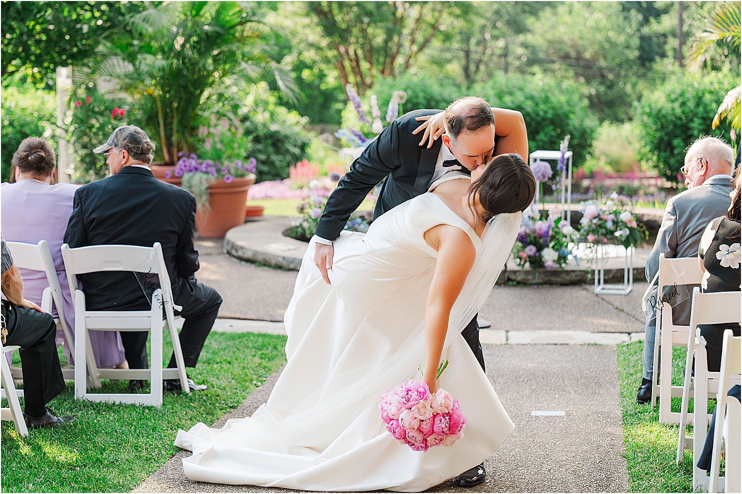 Wedding ceremony dip in the aisle at the end of the ceremony • Wild Weather - Love at a Phipps Conservatory Outdoor Garden Wedding